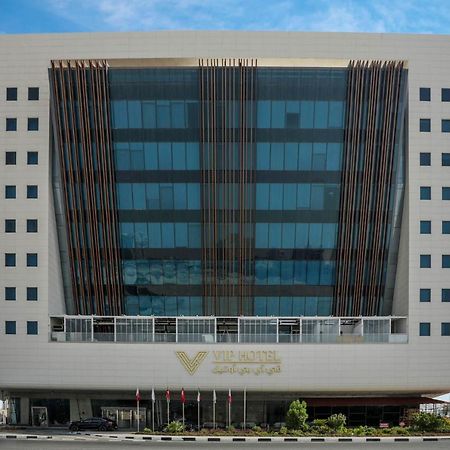 Vip Hotel Doha Qatar Extérieur photo The image shows a modern office building that features a sleek design with a predominantly glass facade. The structure has multiple stories, and the glass windows are framed with decorative elements. The entrance is at the bottom, possibly featuring 
